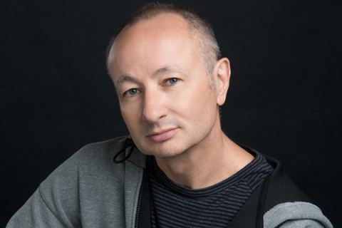 Headshot of Fenton Bailey looking to camera in black tshirt and grey hoodie