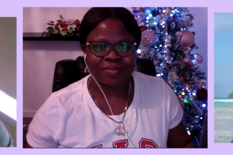 Woman sitting in chair at computer with Christmas decorations in the background