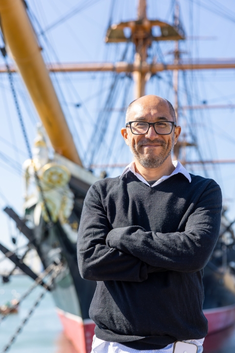 Carlos Ausejo in Portsmouth in front of HMS Warrior - a pioneering iron-hulled ship, launched in 1860, and powered by steam and sail