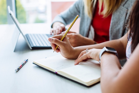 Female lawyer holding a pencil, making notes