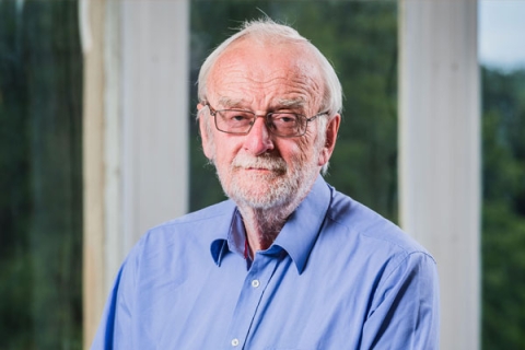 John Craven smiling to camera in headshot
