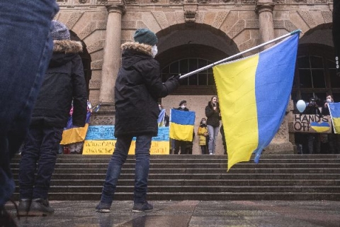 Boy waving flag - Photo by noah eleazar on Unsplash
