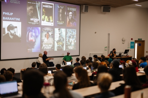 Group of people watching a presentation 