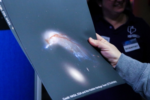 Someone holding a picture showing a solar system