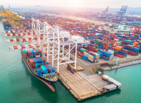 Large ship at industrial port, loading containers