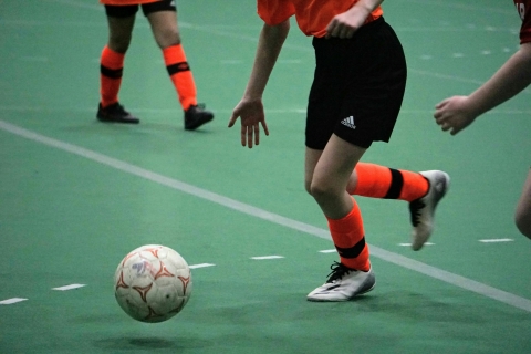 female football player kicking ball