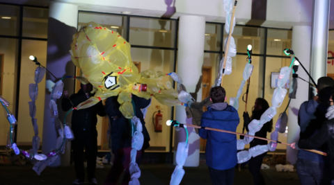 Scientists hold puppets made to communicate science