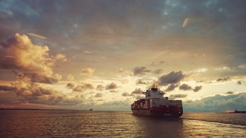 Image of a cargo ship at sunset