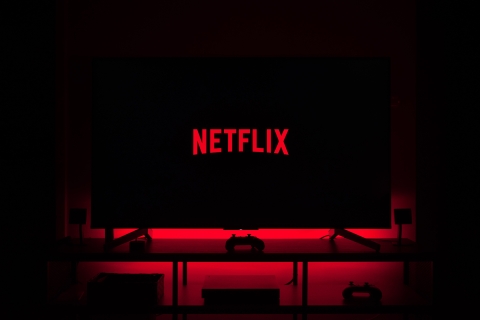 Tv with red  light and with Netflix logo - Photo by Thibault Penin on Unsplash