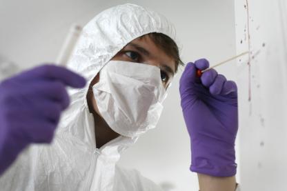 Student collects evidence sample at crime scene