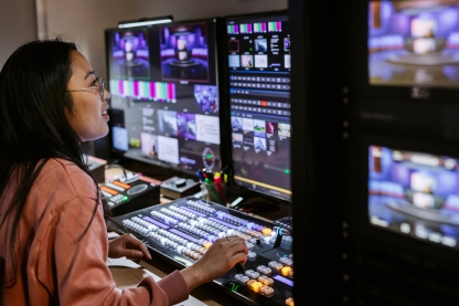 Student in CCI TV Studio Gallery during a live broadcast.