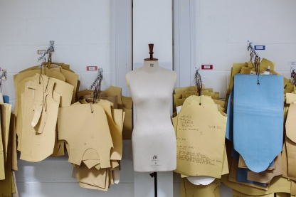 A mannequin with paper patterns flanking it