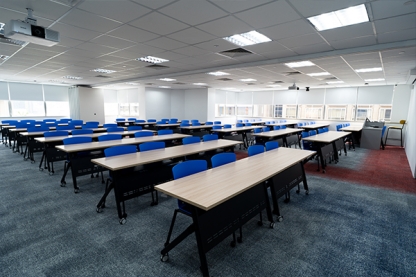 Kaplan classroom with long desks and chairs 