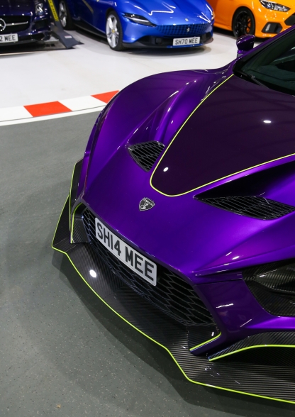 bonnet and number plate of purple sports car by Aaron Widdowson