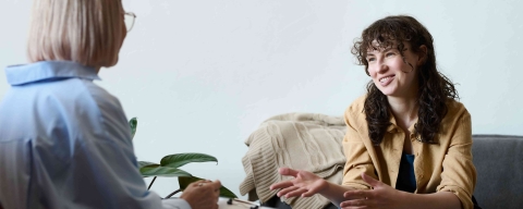 Two women talking in a therapy setting