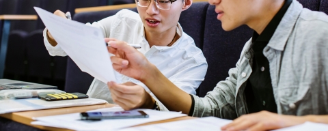 Students discussing notes in pre-sessional English session