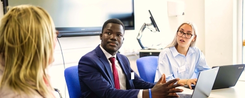 2 law students with a client in the Law Clinic.