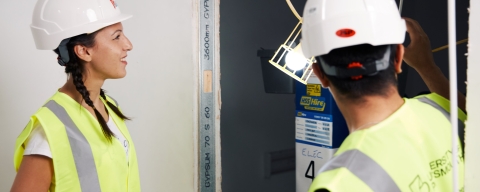 Female civil engineering student at building site