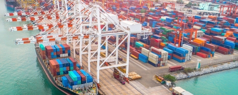Large ship at industrial port, loading containers