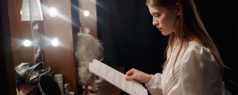 A theatre actor reading a script