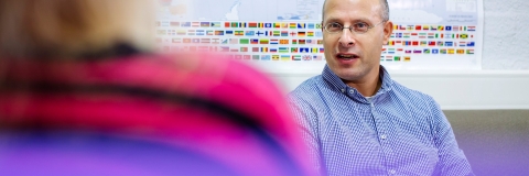 Man having a discussion in front of world map