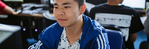 Male student working on computer in computer lab