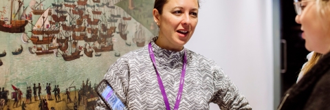 Female employee talking about history, holding a tablet
