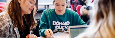 Two women studying and speaking