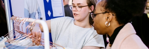 One student admiring self-employed placements student's startup