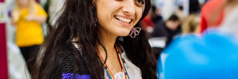 Female employee wearing rainbow lanyard