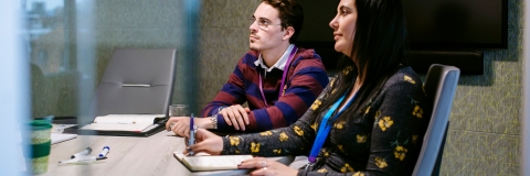 Female and male employee attending an at-work seminar