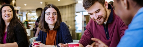 Male and female students in the library cafe