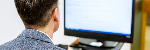 A man looking at a computer screen