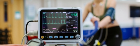  Heart rate monitor tracking student on exercise bike