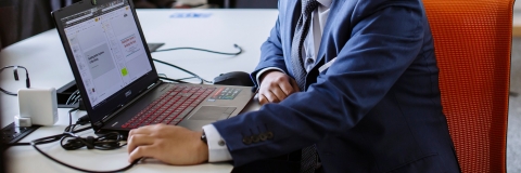 Male student working with laptop at University of Portsmouth