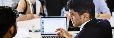 Man working with a colleague at a laptop