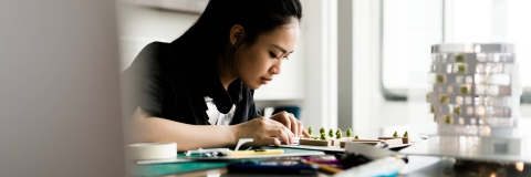 A student working on a 3D architecture model