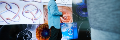 Male student giving presentation in the School of Mathematics and Physics