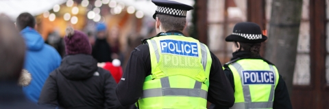 Two police officers in busy street