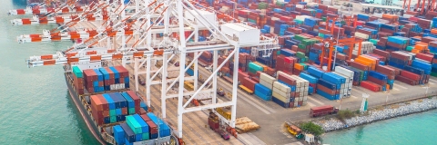 Large ship at industrial port, loading containers