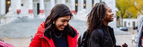 two students at guildhall smiling 