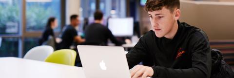  Czech student on laptop in library