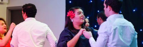 A female student from the Dominican Republic dancing at a festival