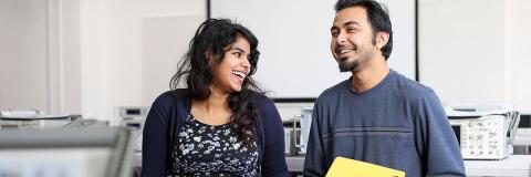 students talking and laughing together in lab