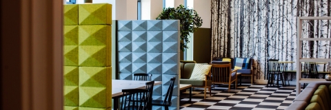 A foam partition with a chair emerging from behind it