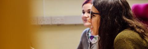 two female students discussing notes