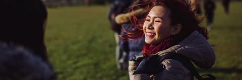 a female student smiling on Southsea common 