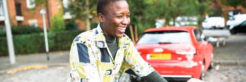 a female student from malawi riding a bicycle through old portsmouth