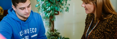 Male student getting advice from female advisor