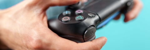 Male gamer holding playstation controller